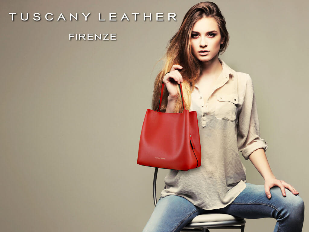 Woman styling a red leather tote with a neutral shirt and jeans